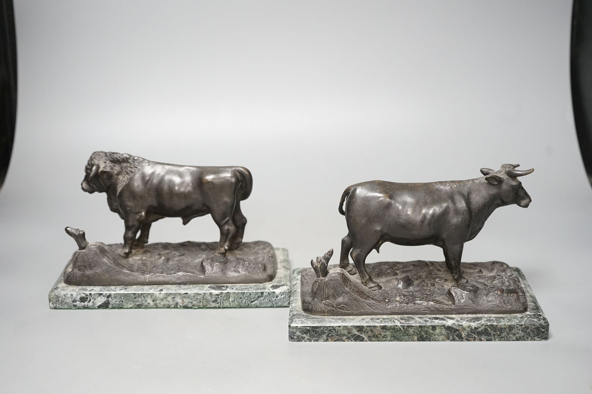 A pair of 20th century bronzes, a cow and a bull, on marble bases, 21cm